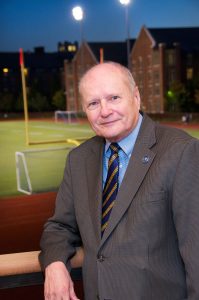 Jim Wyant standing in front of football field