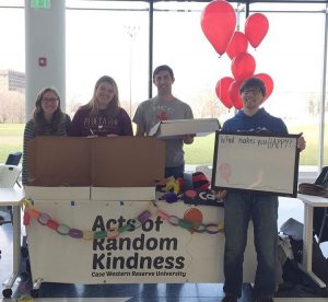 Students from the Acts of Random Kindness organization at a table in Tinkham Veale University Center