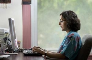 Thrity Umrigar typing on a computer