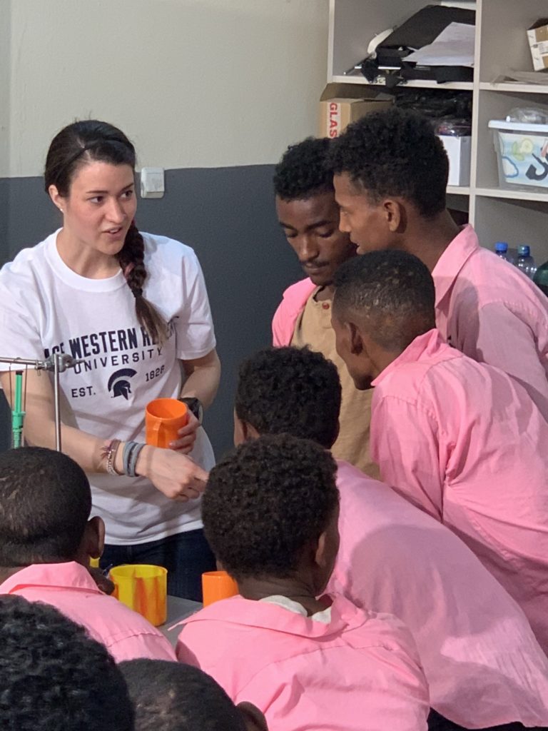 Blaire Volbers surrounded by students in Ethiopia during a science demonstration