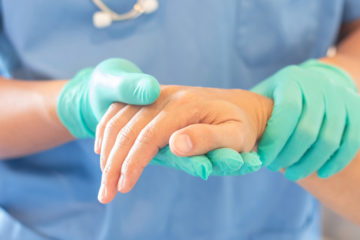 Doctor holding the hand of a patient