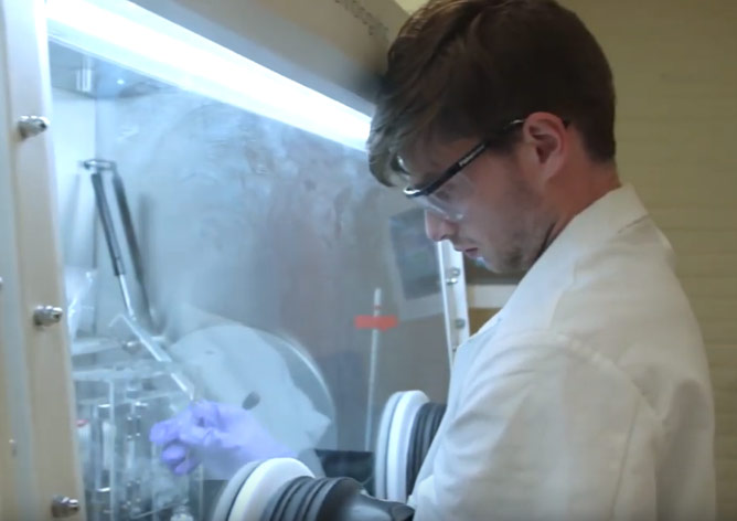 Photo of Henry Squire working in a lab using protective gear